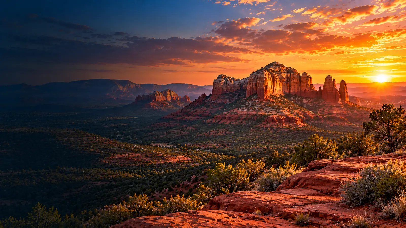 Sedona-inspired Arizona red rock formations and desert valley at sunset